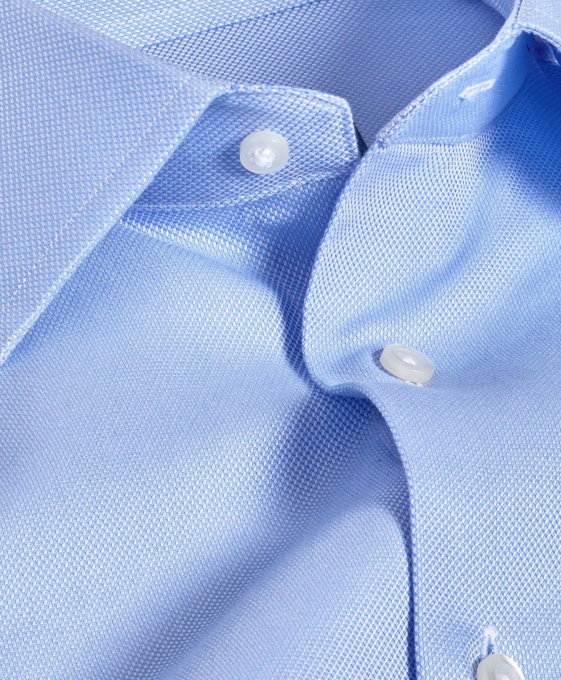 Close view of a sky blue oxford collar and placket