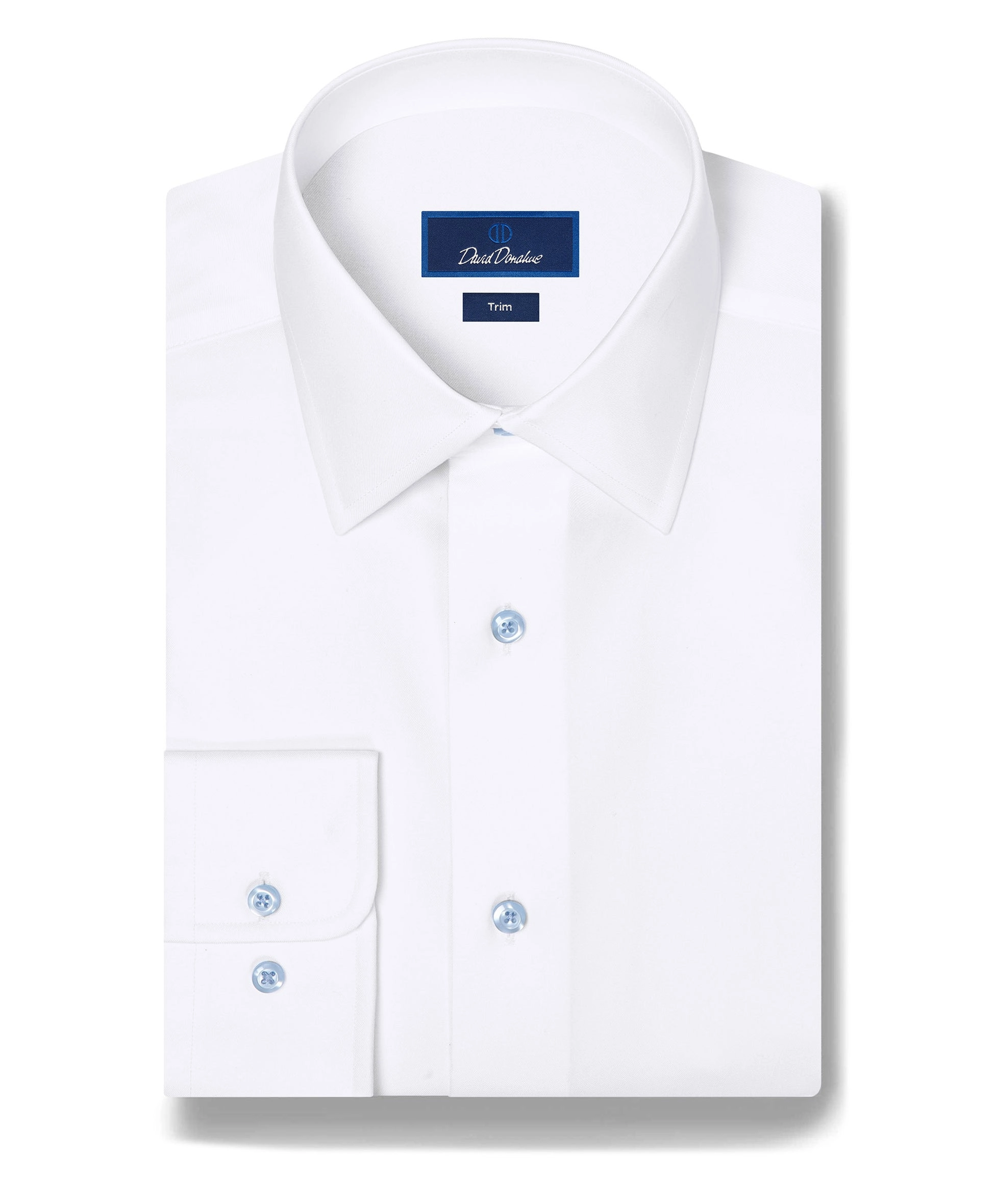 A white dress shirt with pale blue buttons laid flat