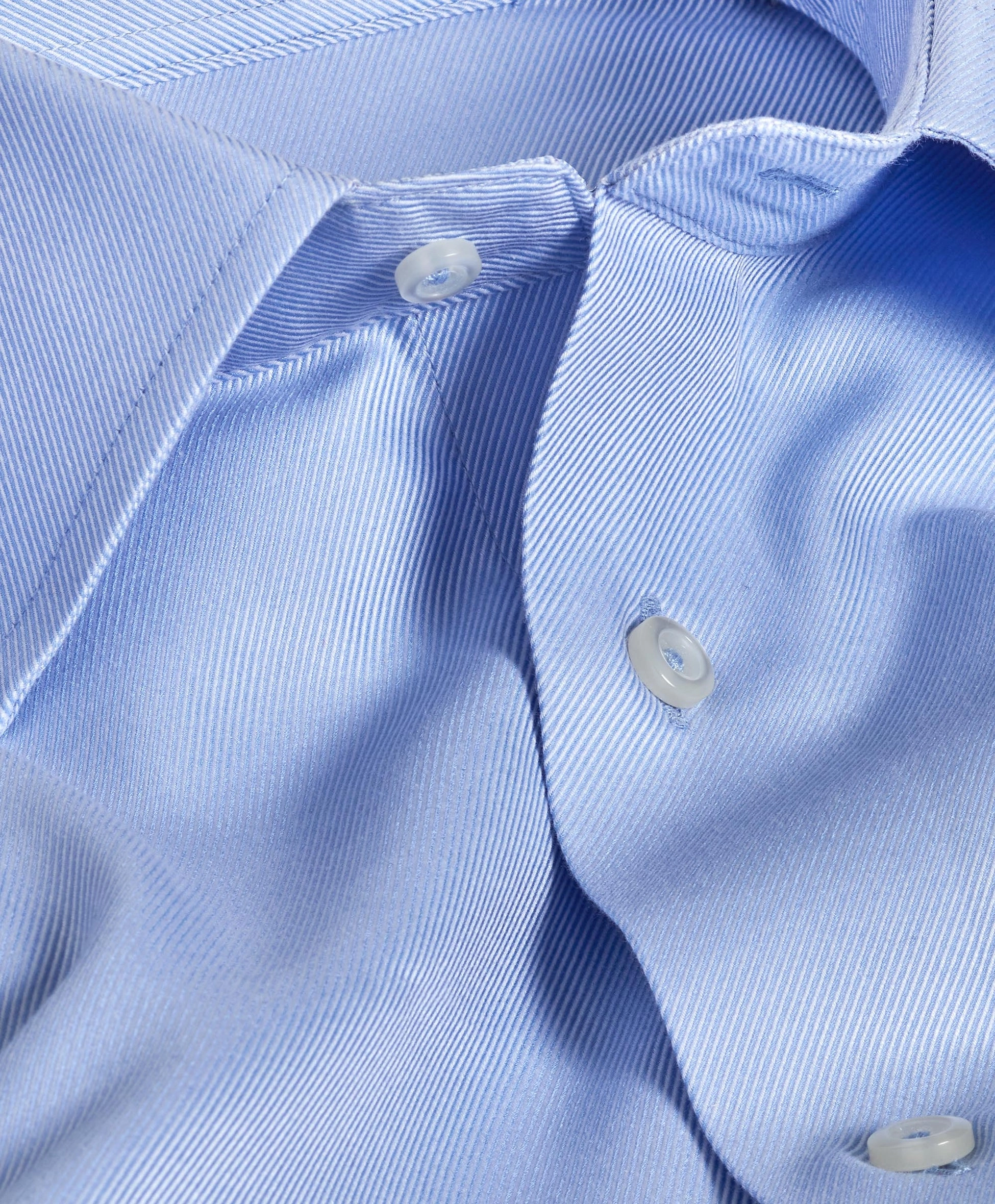 Close view of a sky blue shirt collar and placket