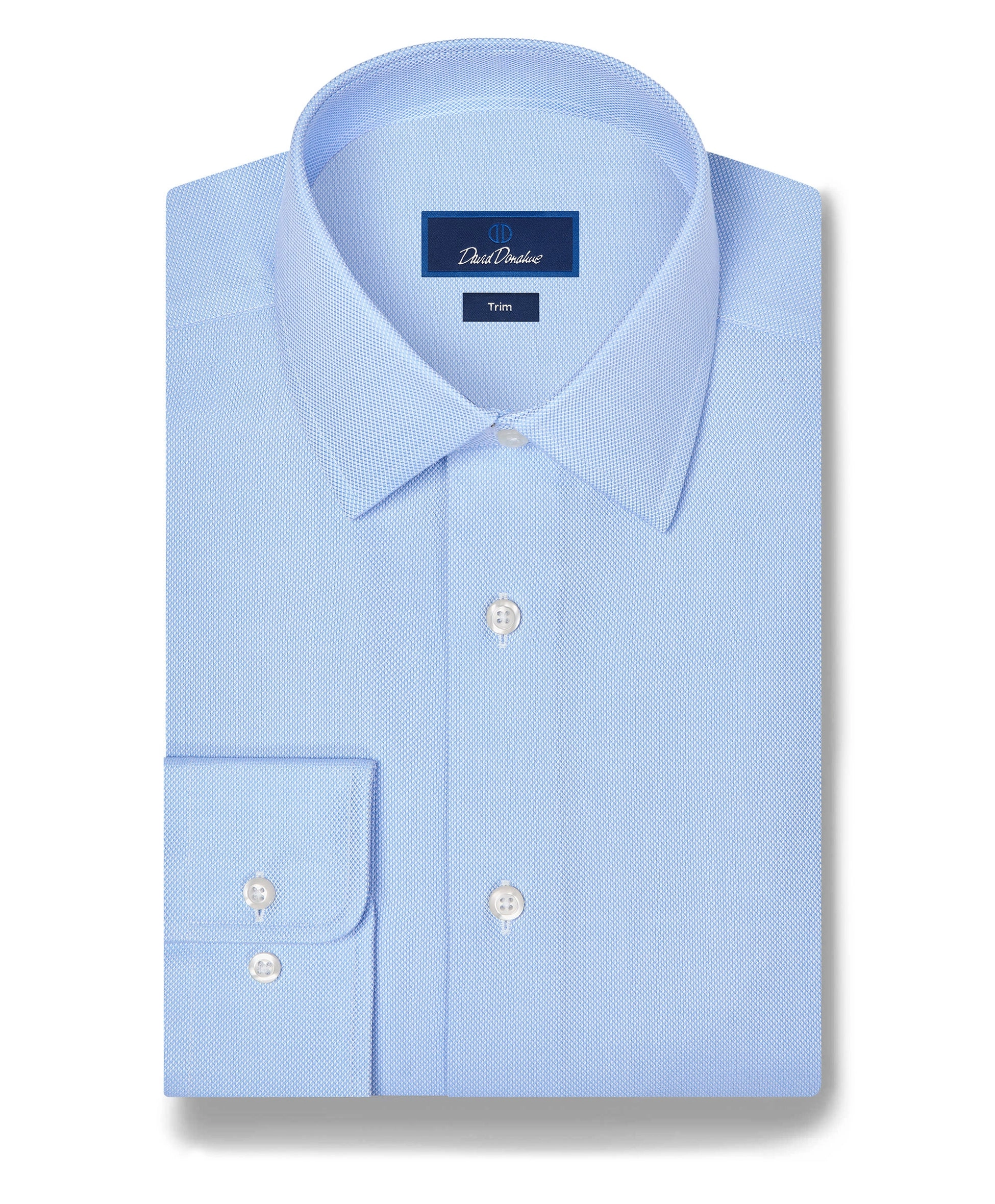 A sky blue barrel cuff dress shirt laid flat